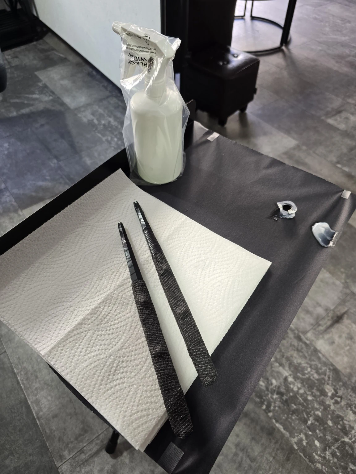 Two hand-held tattoo tools laid out on the prepared workbench.